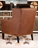 distressed brown leather chair with boot stitch emblem on seat back