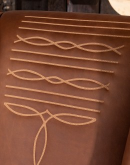 distressed brown leather chair with boot stitch emblem on seat back
