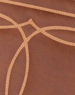 distressed brown leather chair with boot stitch emblem on seat back