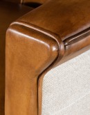 Image of the American-made Polo Club Chair showcasing its full grain leather upholstery with hand burnished details, and luxurious cream nylon tweed-textured fabric wrapping the outside arms and back, signifying modern rustic elegance