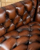 Elegant Tufted Leather Chair with deep button tufting, brass nail accents, and hand-burnished full-grain leather.