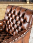 Elegant Tufted Leather Chair with deep button tufting, brass nail accents, and hand-burnished full-grain leather.