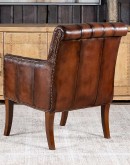 Elegant Tufted Leather Chair with deep button tufting, brass nail accents, and hand-burnished full-grain leather.