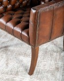 Elegant Tufted Leather Chair with deep button tufting, brass nail accents, and hand-burnished full-grain leather.