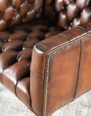 Elegant Tufted Leather Chair with deep button tufting, brass nail accents, and hand-burnished full-grain leather.