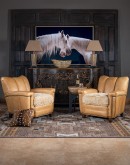 Introducing the Tulip Club Chair - a beautifully designed, American-made chair that's sure to elevate any living space! This image showcases the chair's stunning palomino-colored, full-grain leather and the cream shearling hide seat cushion, which provide