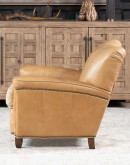 Introducing the Tulip Club Chair - a beautifully designed, American-made chair that's sure to elevate any living space! This image showcases the chair's stunning palomino-colored, full-grain leather and the cream shearling hide seat cushion, which provide