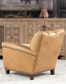 Introducing the Tulip Club Chair - a beautifully designed, American-made chair that's sure to elevate any living space! This image showcases the chair's stunning palomino-colored, full-grain leather and the cream shearling hide seat cushion, which provide