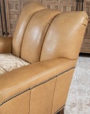 Introducing the Tulip Club Chair - a beautifully designed, American-made chair that's sure to elevate any living space! This image showcases the chair's stunning palomino-colored, full-grain leather and the cream shearling hide seat cushion, which provide