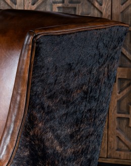 Weston Leather Chair Experience ultimate comfort and luxury with the Weston Leather Chair. This premium wingback chair features a tight back, full grain leather with hand burnished details, and brindle cowhide wrapping along the sides and back. Handcrafted in America with 8-w