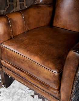 Weston Leather Chair Experience ultimate comfort and luxury with the Weston Leather Chair. This premium wingback chair features a tight back, full grain leather with hand burnished details, and brindle cowhide wrapping along the sides and back. Handcrafted in America with 8-w