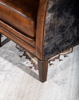 Weston Leather Chair Experience ultimate comfort and luxury with the Weston Leather Chair. This premium wingback chair features a tight back, full grain leather with hand burnished details, and brindle cowhide wrapping along the sides and back. Handcrafted in America with 8-w