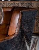 Experience ultimate comfort and luxury with the Weston Leather Chair. This premium wingback chair features a tight back, full grain leather with hand burnished details, and brindle cowhide wrapping along the sides and back. Handcrafted in America with 8-w