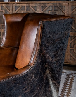 Weston Leather Chair Experience ultimate comfort and luxury with the Weston Leather Chair. This premium wingback chair features a tight back, full grain leather with hand burnished details, and brindle cowhide wrapping along the sides and back. Handcrafted in America with 8-w