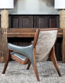 Yachtsman’s Sky Leather Chair with grey-blue leather, black walnut frame, and brindle cowhide back, accented with nickel nail heads.