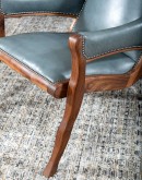 Yachtsman’s Sky Leather Chair with grey-blue leather, black walnut frame, and brindle cowhide back, accented with nickel nail heads.