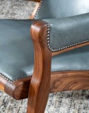 Yachtsman’s Sky Leather Chair with grey-blue leather, black walnut frame, and brindle cowhide back, accented with nickel nail heads.