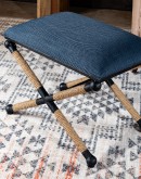 Cobalt Foot Stool featuring a rustic iron frame interwoven with natural fiber rope accents for a nautical touch, and a plush, textured navy blue cotton blend cushion.