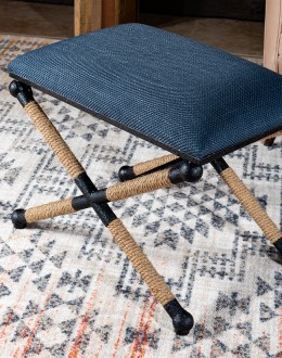 Cobalt Foot Stool featuring a rustic iron frame interwoven with natural fiber rope accents for a nautical touch, and a plush, textured navy blue cotton blend cushion.
