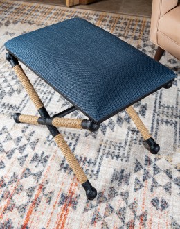 Cobalt Foot Stool featuring a rustic iron frame interwoven with natural fiber rope accents for a nautical touch, and a plush, textured navy blue cotton blend cushion.