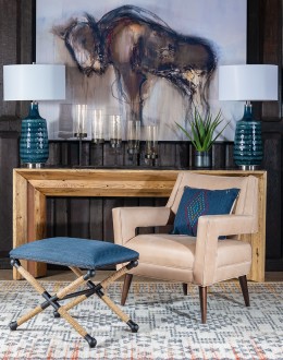 Cobalt Foot Stool featuring a rustic iron frame interwoven with natural fiber rope accents for a nautical touch, and a plush, textured navy blue cotton blend cushion.