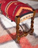small bench with kilim rug on top