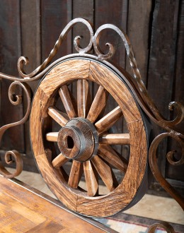 Rustic Pioneer Wagon Wheel Bench made of hand-forged iron and wire-wheeled Chilean Pine, comfortably seating three people, with a distinctive wagon wheel design integrated into the middle