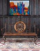 Rustic Pioneer Wagon Wheel Bench made of hand-forged iron and wire-wheeled Chilean Pine, comfortably seating three people, with a distinctive wagon wheel design integrated into the middle