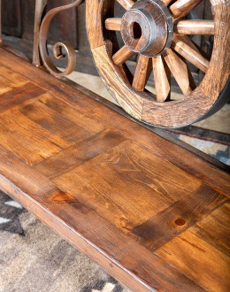 Rustic Pioneer Wagon Wheel Bench made of hand-forged iron and wire-wheeled Chilean Pine, comfortably seating three people, with a distinctive wagon wheel design integrated into the middle