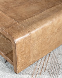 Modern rustic Sonora Sand Leather Coffee Table  featuring a rectangular shape with waterfall edge design, wrapped in fun grain saddle leather in palomino color. Includes a lower open shelf for storage or decoration.