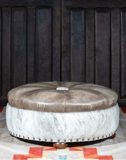 Cowboy Greyson Ottoman 36 inch round ottoman with grey leather top and grey brindle cowhide on the base