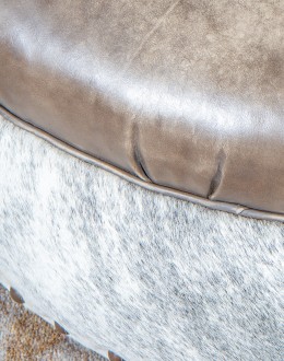 36 inch round ottoman with grey leather top and grey brindle cowhide on the base