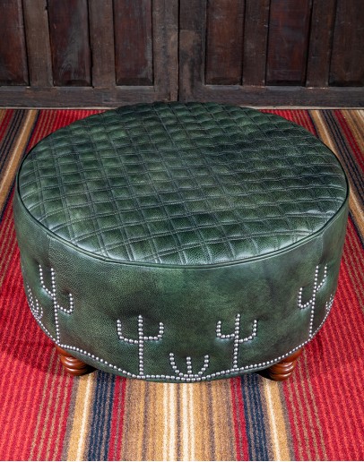 Legends Cacti Ottoman 32'' round American-made Legends Cacti Ottoman upholstered in top grain green leather with hand burnished details, featuring nickel nail trim with cactus patterns around the base and a quilted diamond pattern on top.