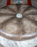 36 inch round ottoman with grey leather top and grey brindle cowhide on the base