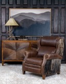 The Bronco Brindleback Recliner: A masterfully crafted, American-made recliner with a grand scale, bustle back, and supple light brown leather. Upholstery-grade brindle cowhide and gold-colored nail tacks add a touch of Western charm. Experience ultimate