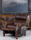 The Bronco Brindleback Recliner: A masterfully crafted, American-made recliner with a grand scale, bustle back, and supple light brown leather. Upholstery-grade brindle cowhide and gold-colored nail tacks add a touch of Western charm. Experience ultimate