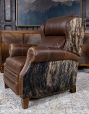 The Bronco Brindleback Recliner: A masterfully crafted, American-made recliner with a grand scale, bustle back, and supple light brown leather. Upholstery-grade brindle cowhide and gold-colored nail tacks add a touch of Western charm. Experience ultimate