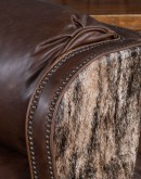The Bronco Brindleback Recliner: A masterfully crafted, American-made recliner with a grand scale, bustle back, and supple light brown leather. Upholstery-grade brindle cowhide and gold-colored nail tacks add a touch of Western charm. Experience ultimate