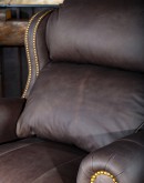 The Bronco Brindleback Recliner: A masterfully crafted, American-made recliner with a grand scale, bustle back, and supple light brown leather. Upholstery-grade brindle cowhide and gold-colored nail tacks add a touch of Western charm. Experience ultimate