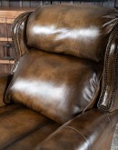 A luxurious Bronco Beretta Leather Recliner in rich brown top grain leather, featuring hand-burnished details, brass nail tacks, leather welting, and a bustleback design for optimal head and neck support.