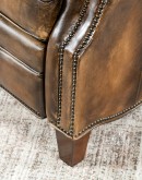 A luxurious Bronco Beretta Leather Recliner in rich brown top grain leather, featuring hand-burnished details, brass nail tacks, leather welting, and a bustleback design for optimal head and neck support.