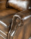 A luxurious Bronco Beretta Leather Recliner in rich brown top grain leather, featuring hand-burnished details, brass nail tacks, leather welting, and a bustleback design for optimal head and neck support.