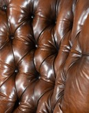 dark saddle leather recliner with tufted back