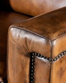 Image of Revolver Bourbon Leather Recliner featuring sleek, tapered arms, bustle back, and full-grain leather with hand-burnished details, showcasing its luxurious, modern rustic design