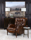 distressed leather recliner with button tufting on seat and back