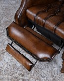 distressed leather recliner with button tufting on seat and back