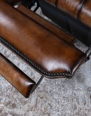 distressed leather recliner with button tufting on seat and back