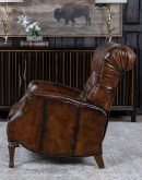 distressed leather recliner with button tufting on seat and back