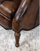 distressed leather recliner with button tufting on seat and back