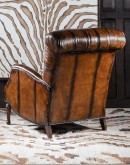 distressed leather recliner with button tufting on seat and back